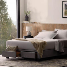 Load image into Gallery viewer, side view of Malouf Duncan Platform Bed Base with a bed in a room
